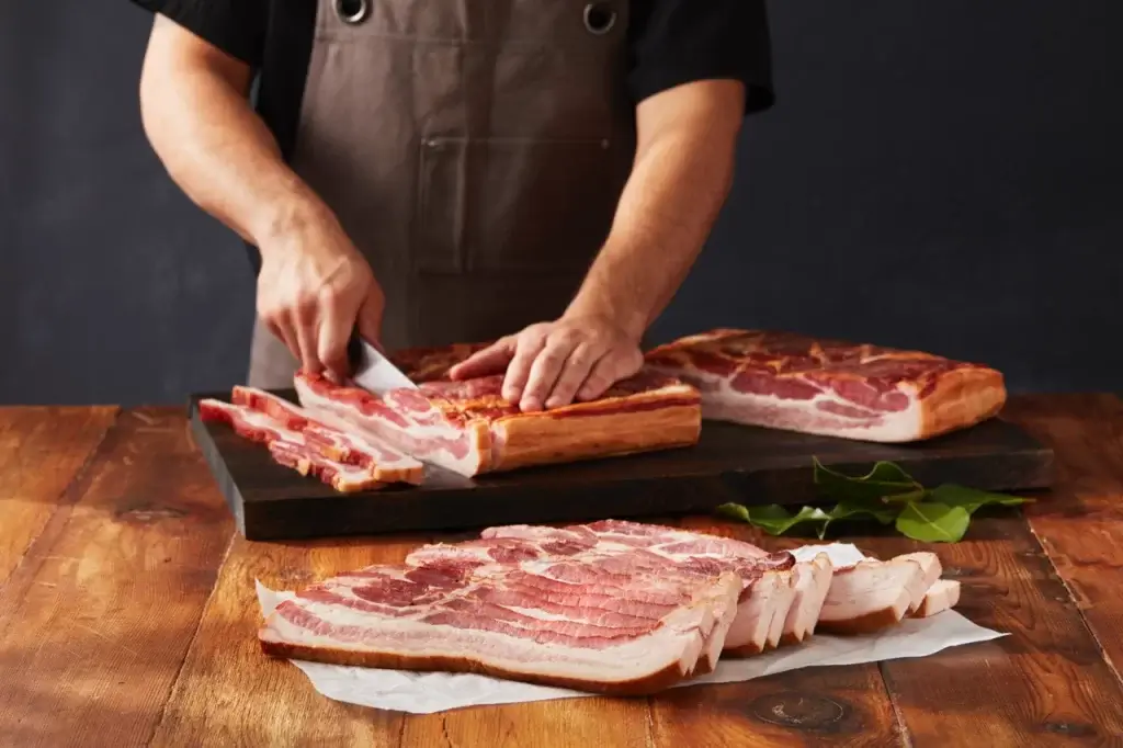 Man Cutting Daily's Pork Bacon